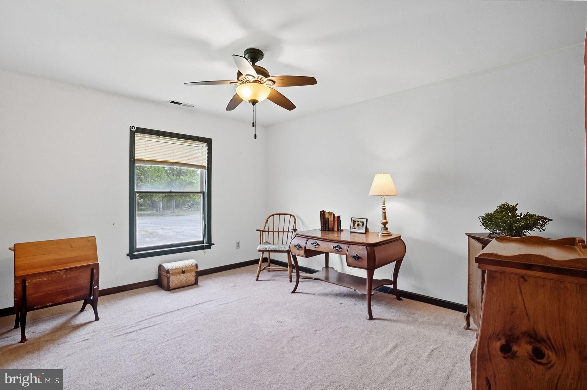 5304 Cassons Neck Road Cambridge, MD 21613 - Photo 37 of 46 a living room with furniture and a window