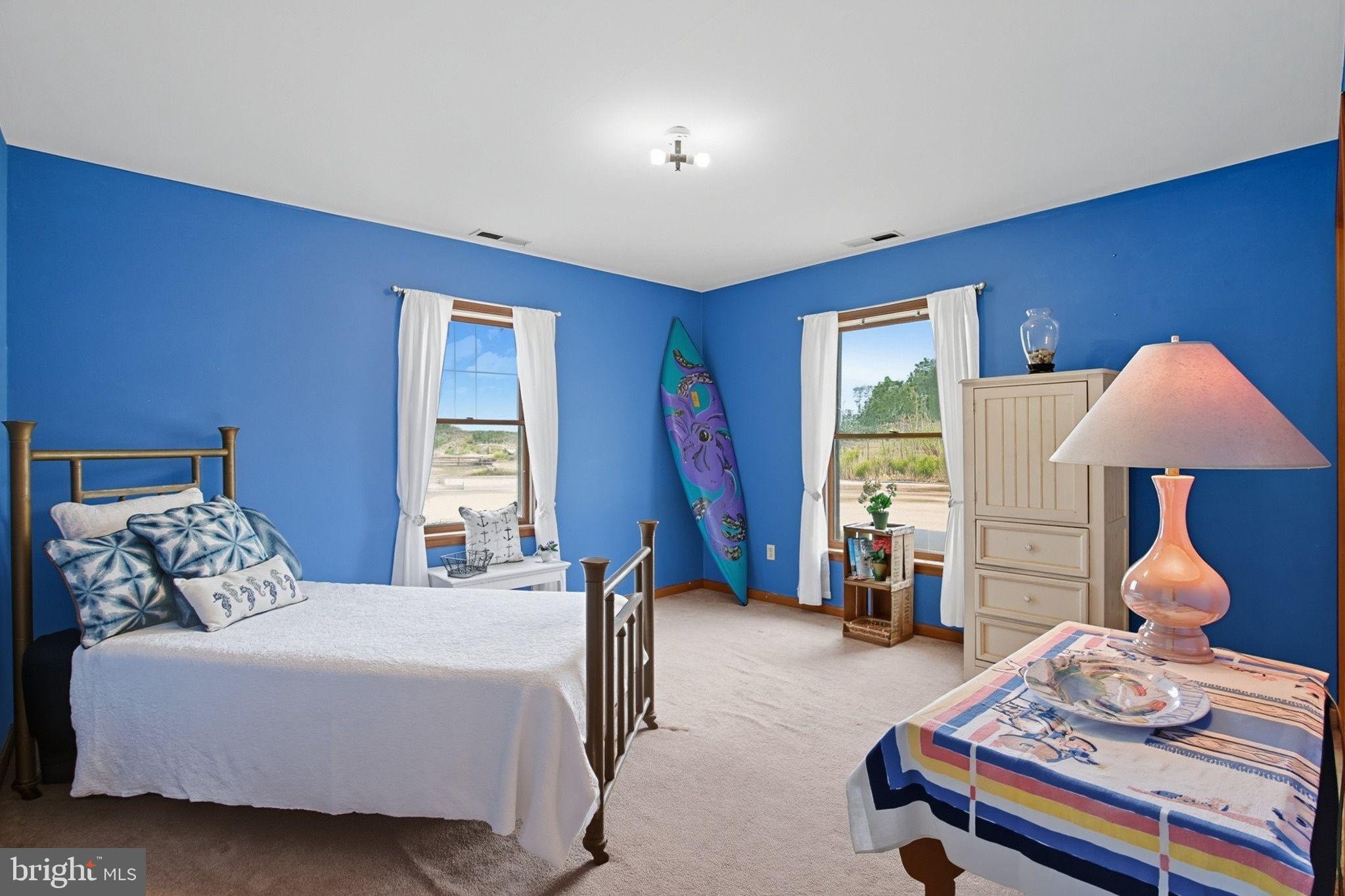 5304 Cassons Neck Road Cambridge, MD 21613 - Photo 41 of 46 a bedroom with a bed and a chandelier