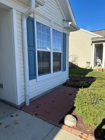 a front view of a house with a garden