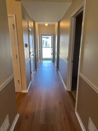a view of a hallway with wooden floor