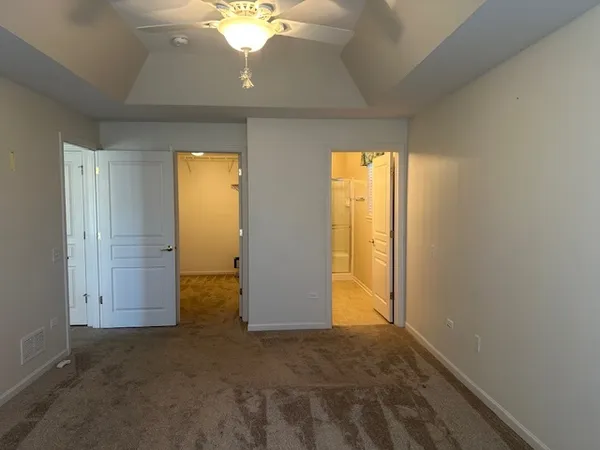 an empty room with windows and closet