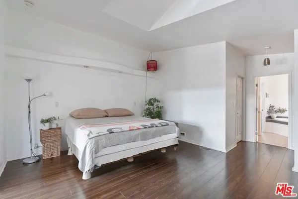 a bedroom with a bed and a table
