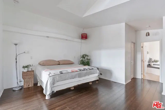 a bedroom with a bed and a table