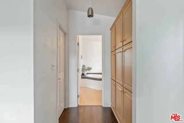 a view of a hallway with wooden floor and staircase