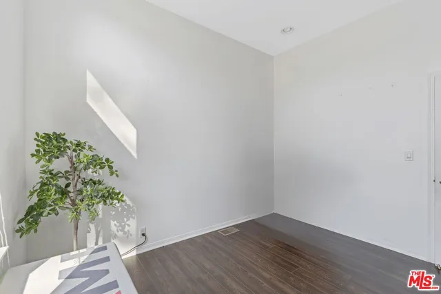 a view of a room with wooden floor and plant