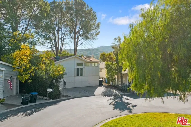 a view of a house with swimming pool and sitting area