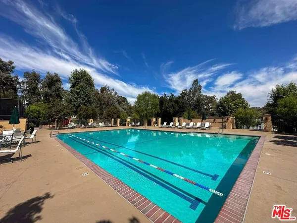 a view of a swimming pool and outdoor seating
