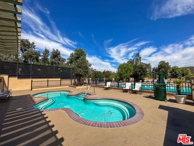 a swimming pool with outdoor seating and yard