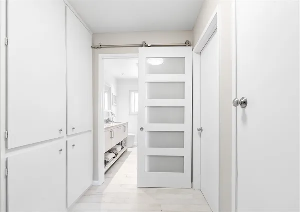 a bathroom with a granite countertop sink a toilet and a mirror