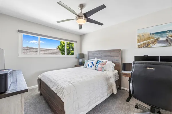a bedroom with bed and a chandelier
