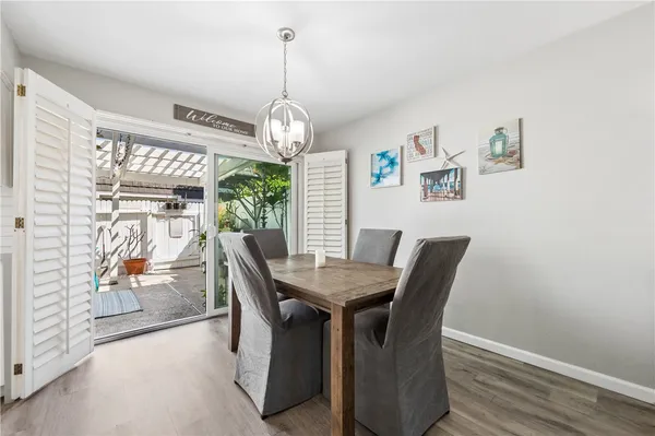 a view of a dining room with furniture wooden floor and chandelier