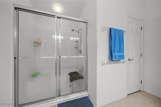 a bathroom with a shower and a sink