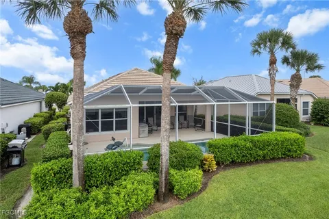 a view of a house with a yard and potted plants