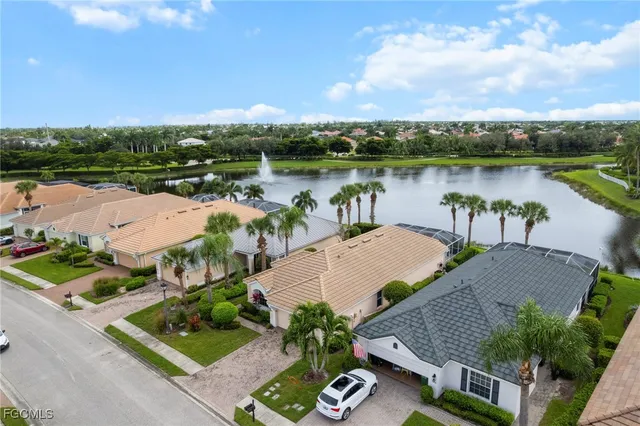 an aerial view of a house with outdoor space and lake view in back