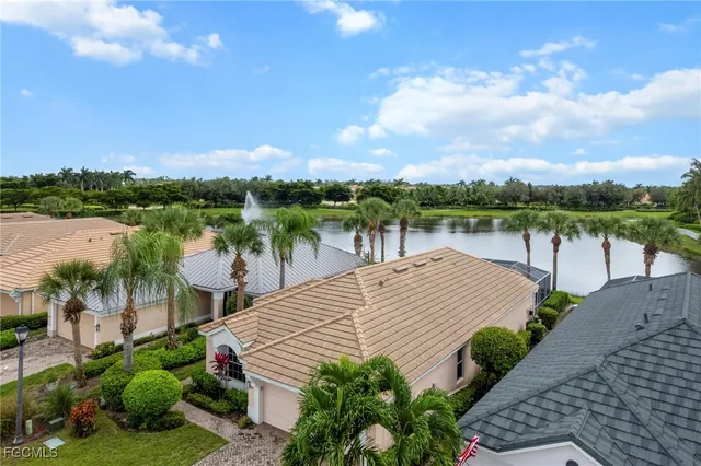 a view of a lake with plants and large trees