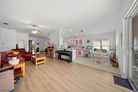 a living room with lots of furniture and a wooden floor