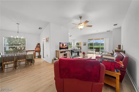 a living room with furniture a fireplace and a window