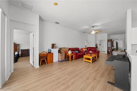 a view of a room with wooden floor and furniture