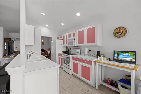 a kitchen that has a lot of cabinets in it and a sink