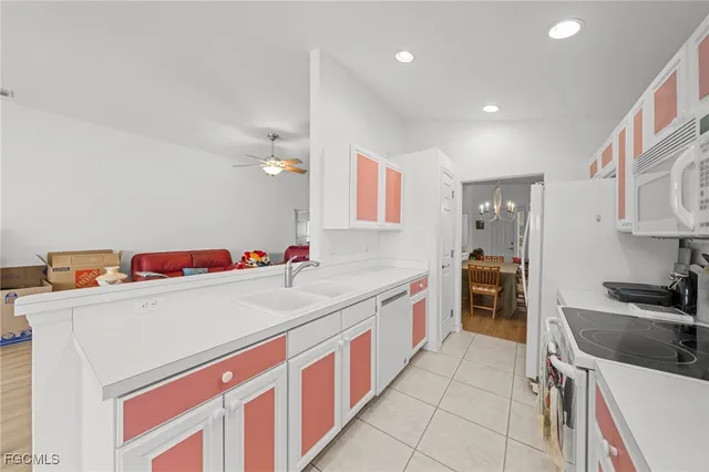 a utility room with cabinets washer and dryer