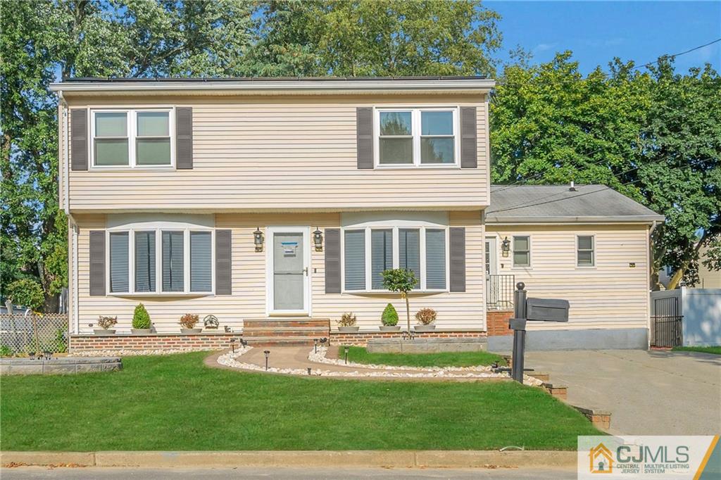 16 Channing Road East Brunswick, NJ 08816 - Photo 1 of 36 a front view of a house with a yard table and chairs