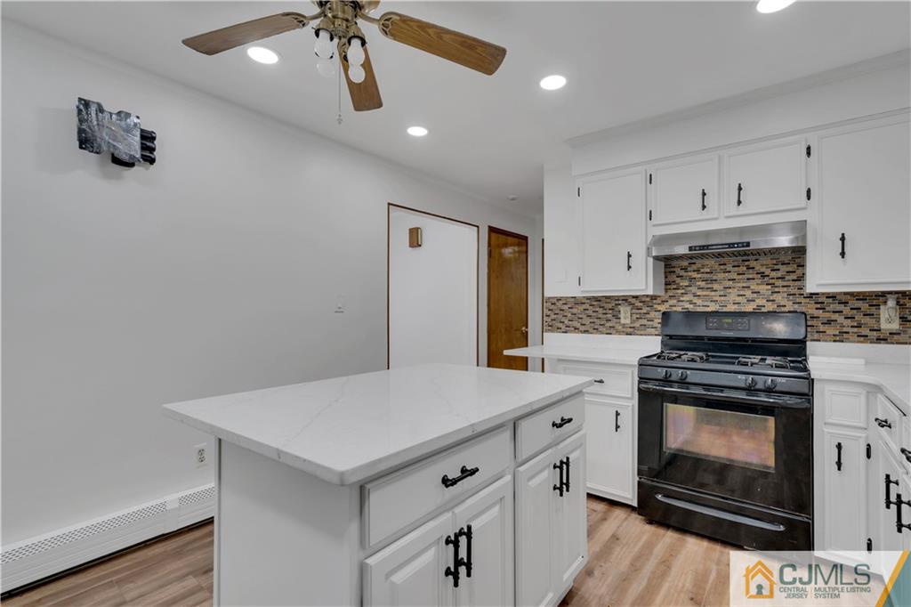 16 Channing Road East Brunswick, NJ 08816 - Photo 11 of 36 a kitchen with a stove cabinets and wooden floor