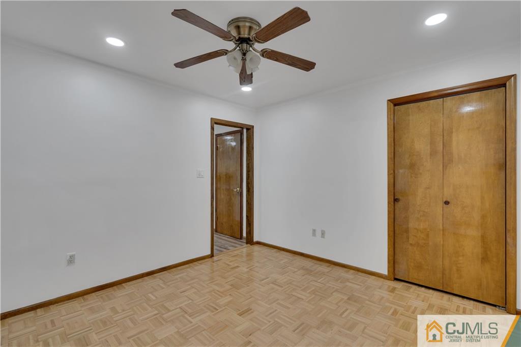 16 Channing Road East Brunswick, NJ 08816 - Photo 15 of 36 an empty room with a ceiling fan and a window
