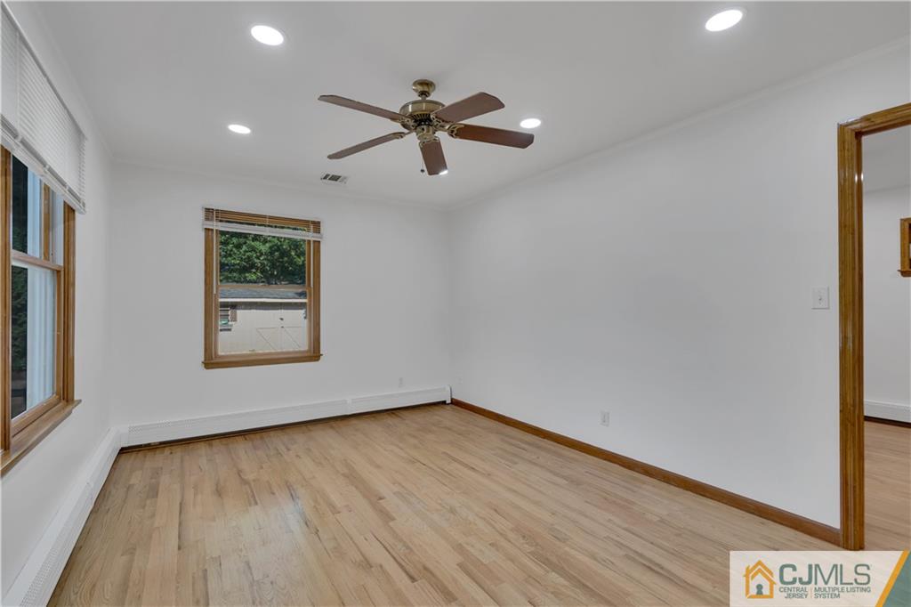 16 Channing Road East Brunswick, NJ 08816 - Photo 16 of 36 a view of an empty room with wooden floor and a window