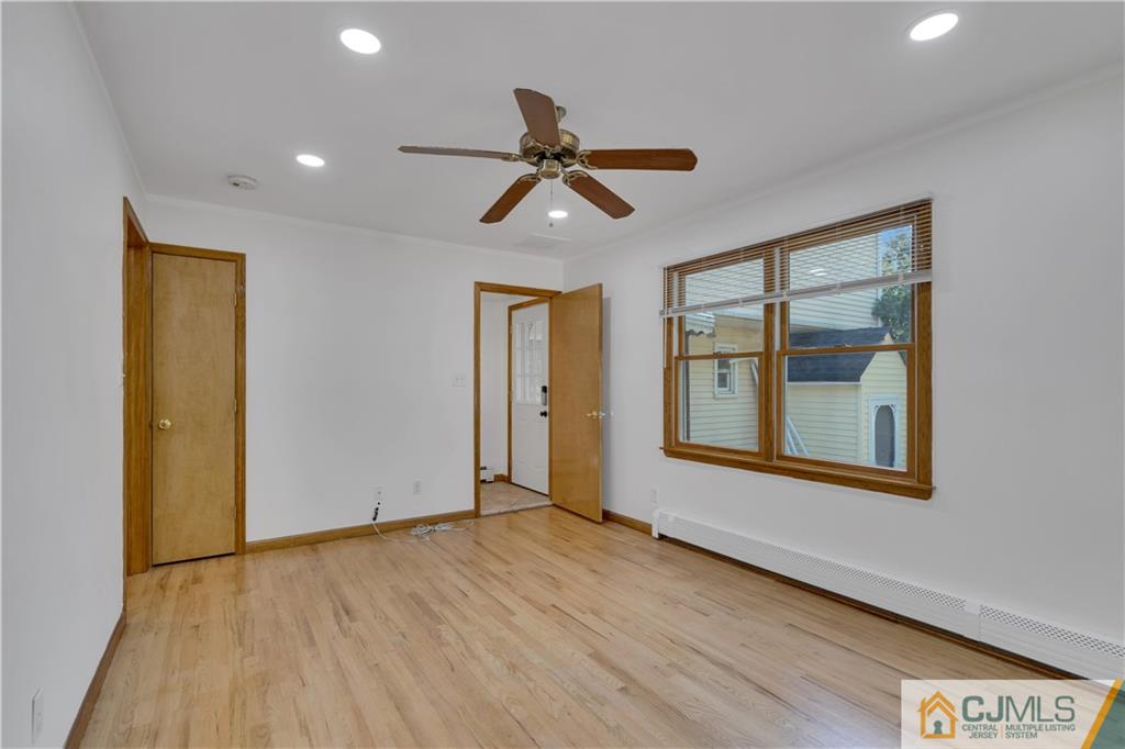 16 Channing Road East Brunswick, NJ 08816 - Photo 17 of 36 a view of an empty room with window and wooden floor