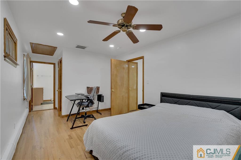 16 Channing Road East Brunswick, NJ 08816 - Photo 19 of 36 a bedroom with a bed and a chandelier