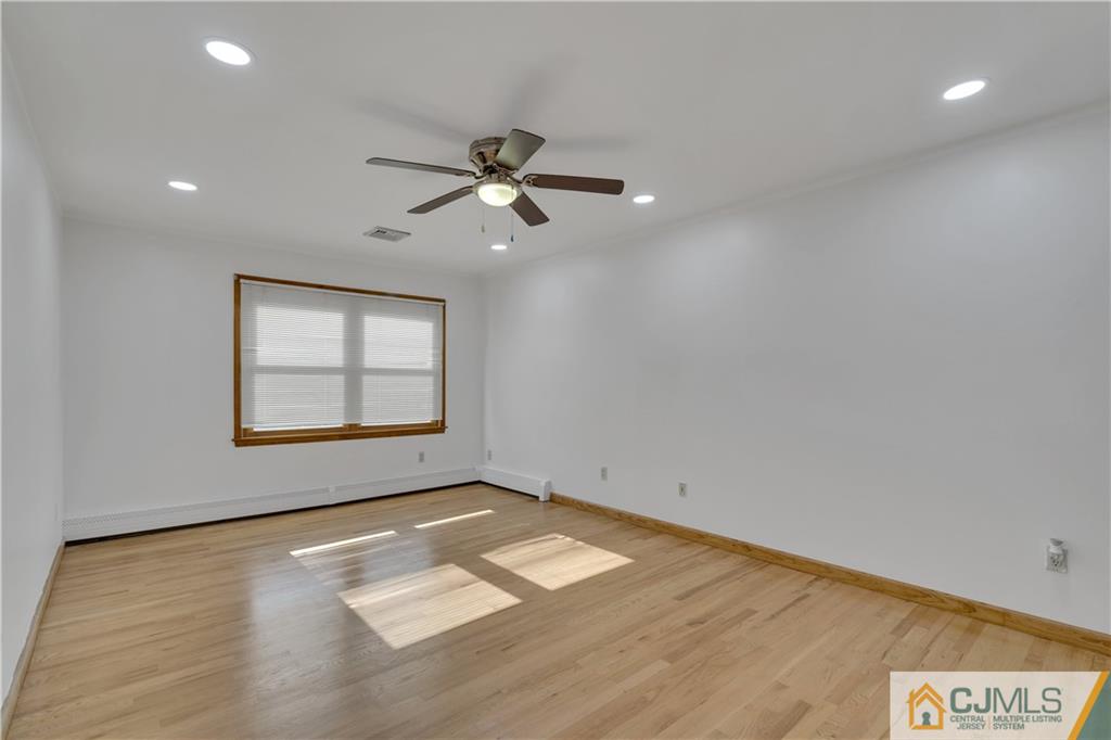 16 Channing Road East Brunswick, NJ 08816 - Photo 21 of 36 wooden floor in an empty room with a window