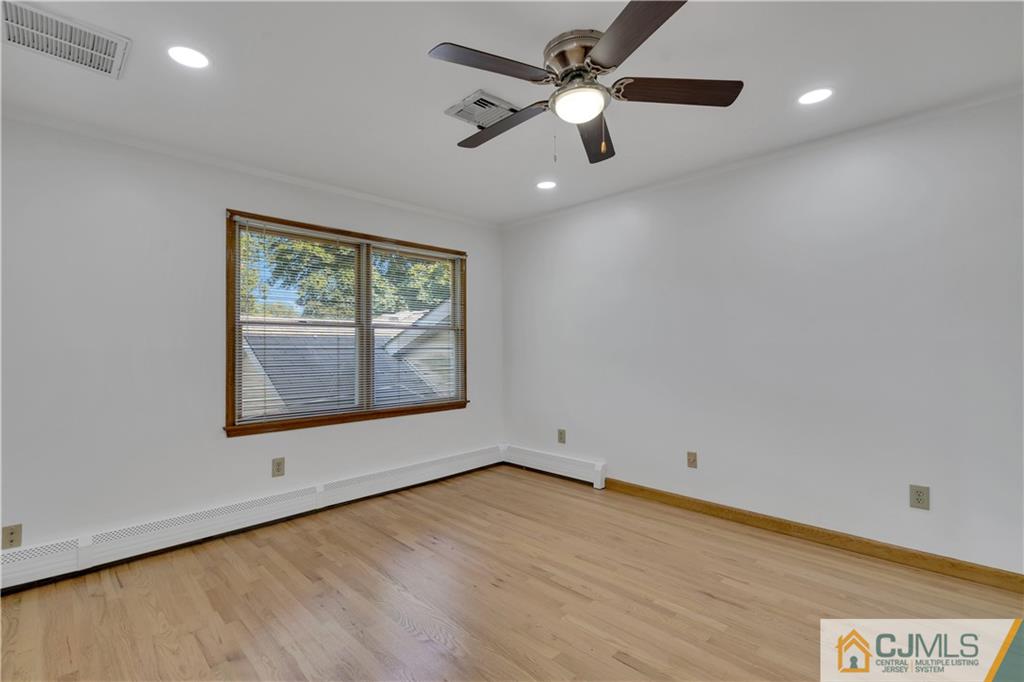 16 Channing Road East Brunswick, NJ 08816 - Photo 25 of 36 an empty room with a window and a ceiling fan