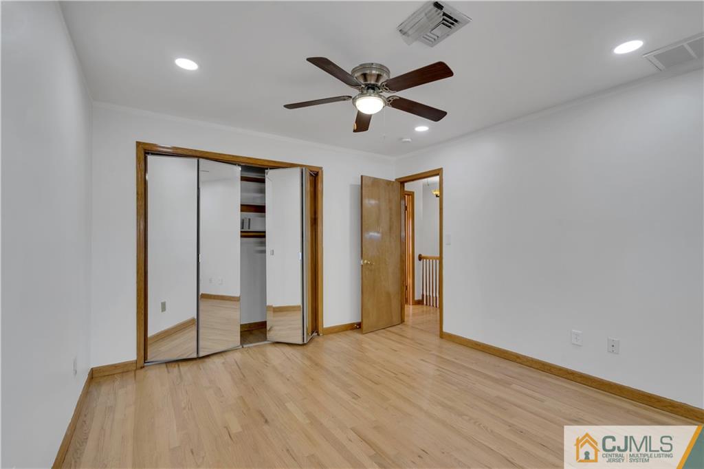 16 Channing Road East Brunswick, NJ 08816 - Photo 26 of 36 a view of an empty room with wooden floor and a ceiling fan