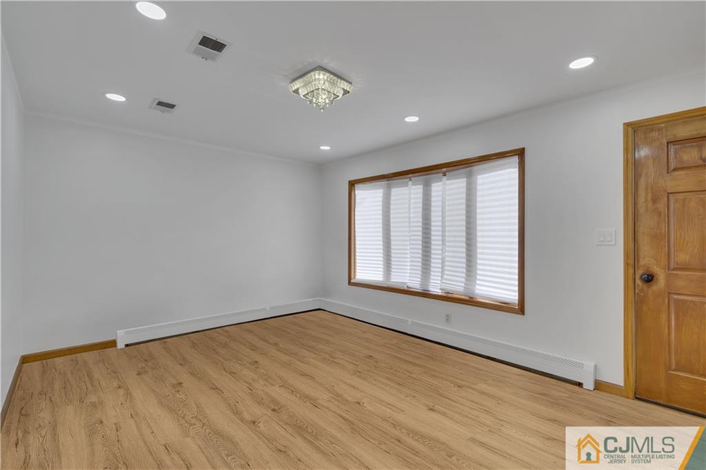 16 Channing Road East Brunswick, NJ 08816 - Photo 3 of 36 a view of an empty room with wooden floor and a window