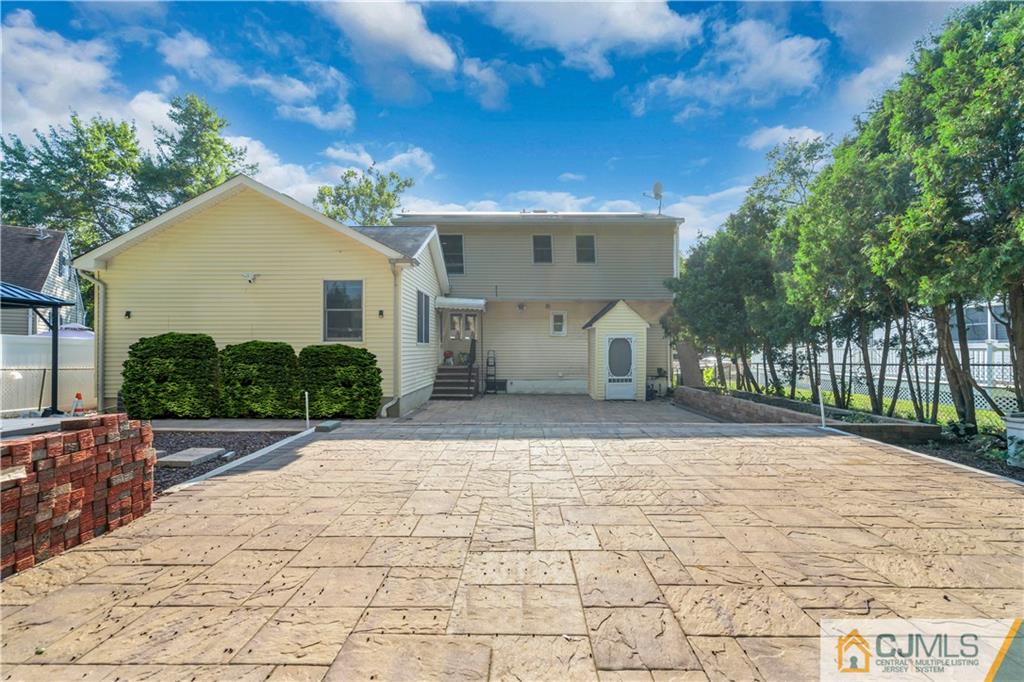 16 Channing Road East Brunswick, NJ 08816 - Photo 31 of 36 a front view of a house with a yard and a garage