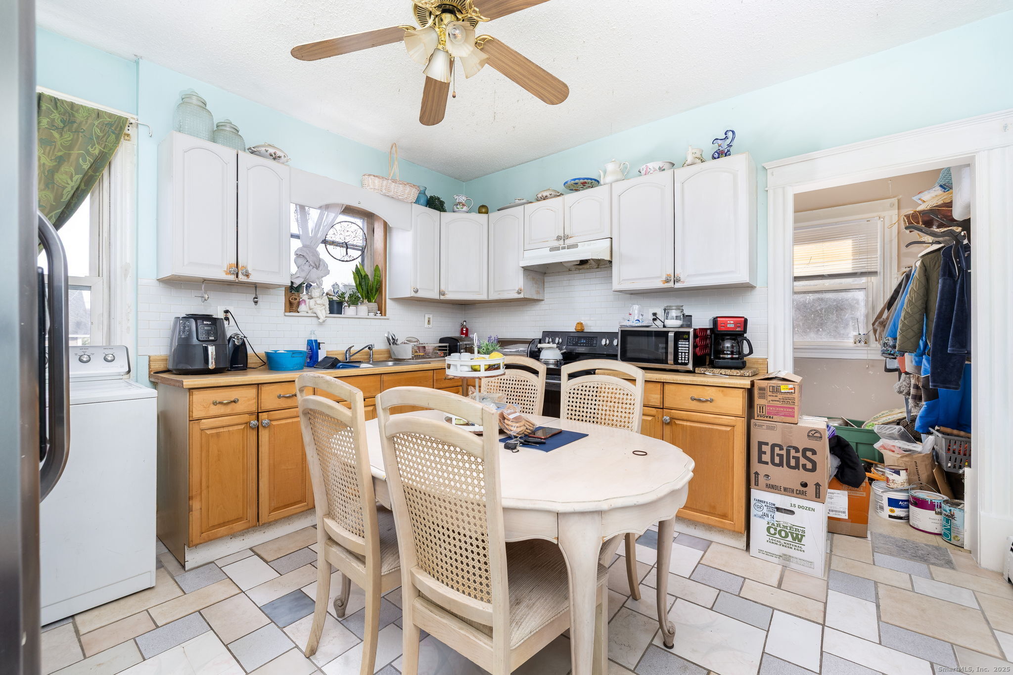 372 Pleasant Street Windham, CT 06226 - Photo 21 of 30 a kitchen with stainless steel appliances granite countertop a sink a stove a refrigerator cabinets and chairs