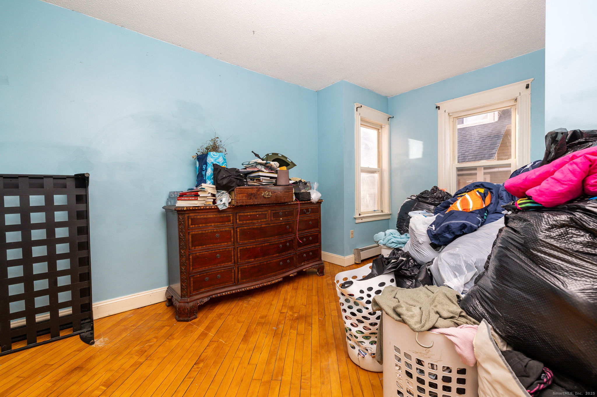 372 Pleasant Street Windham, CT 06226 - Photo 22 of 30 a bedroom with a bed and wooden floor