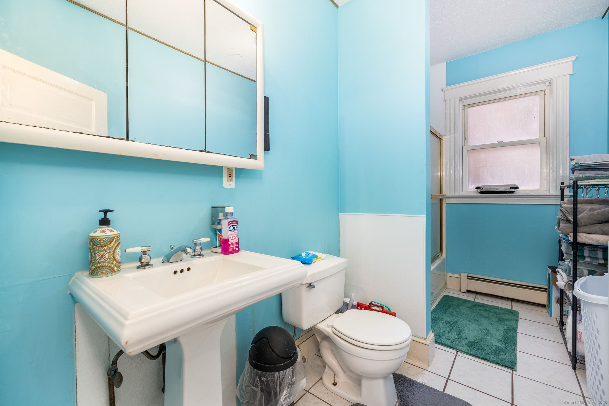 372 Pleasant Street Windham, CT 06226 - Photo 24 of 30 a bathroom with a sink toilet and a window