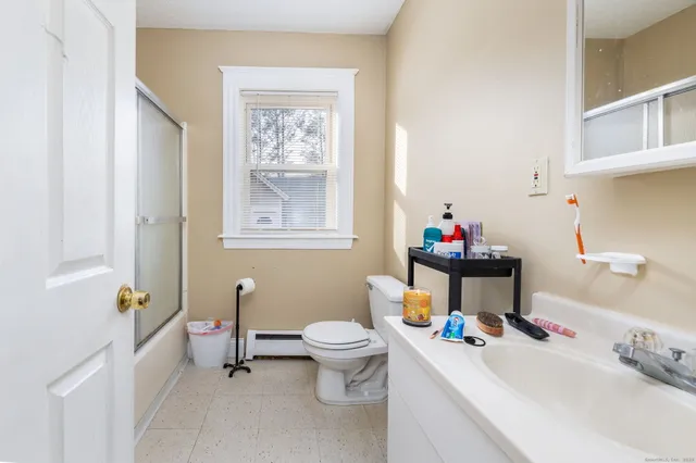 a bathroom with a sink toilet and a mirror