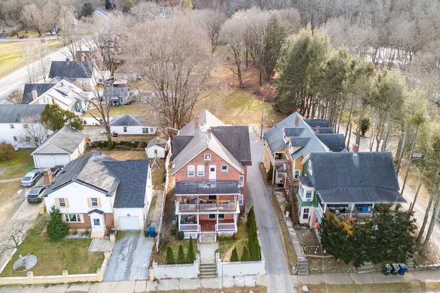a aerial view of a residential apartment building with a yard