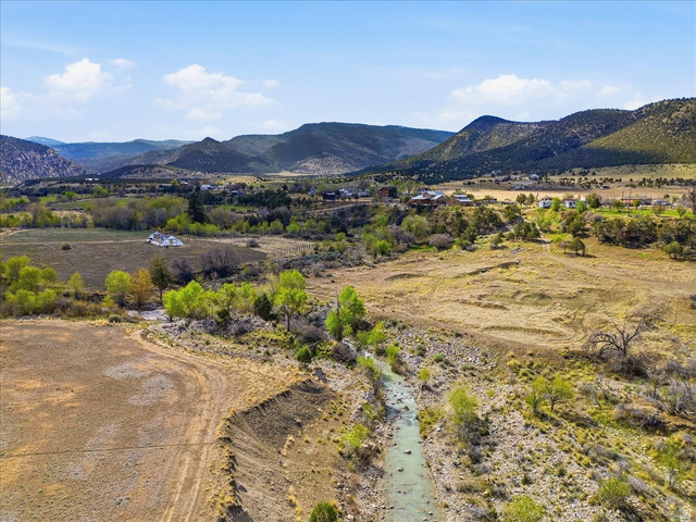 811 East Canyon Road Mayfield, UT 84643 - Photo 51 of 57 Expansive natural landscape featuring a winding river, mature trees, open fields, and distant mountainous terrain