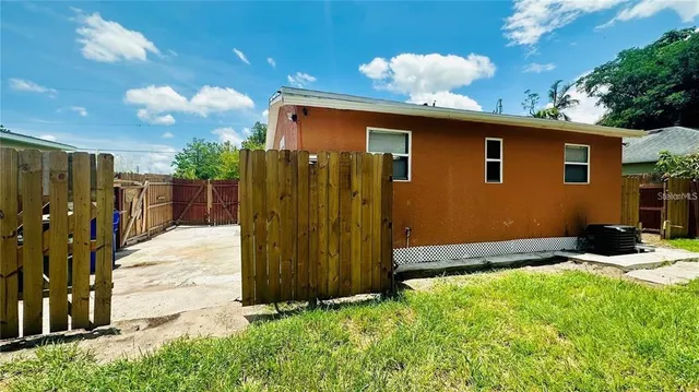 a backyard of a house with yard and outdoor seating