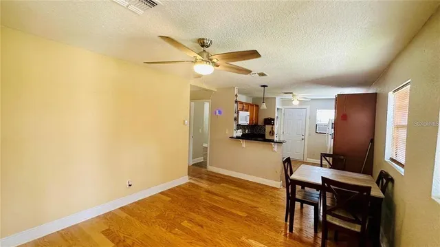 a view of a workspace with furniture and a fan