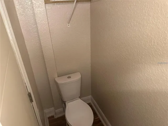 a white toilet sitting next to a shower