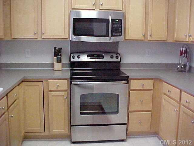 296 Elis Way, Unit 156 Fort Mill, SC 29708 - Photo 3 of 16 a kitchen with stainless steel appliances granite countertop a stove and a microwave