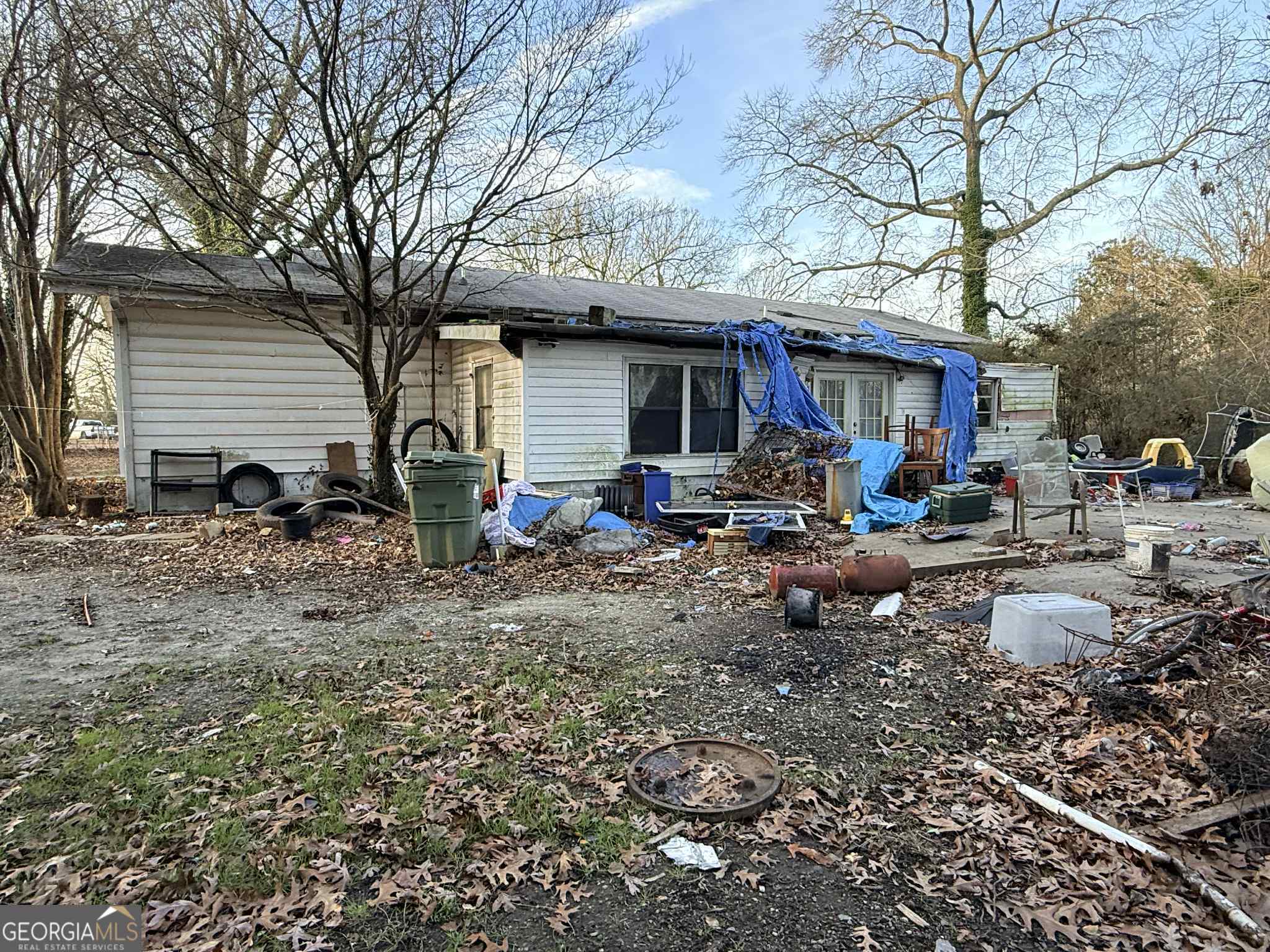 250 Robin Hood Lane Hampton, GA 30228 - Photo 3 of 4 a backyard of a house with barbeque oven table and chairs