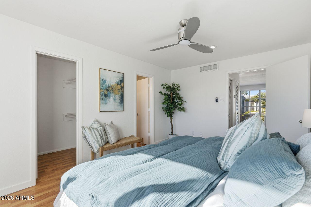 1012 East Osborn Road, Unit E Phoenix, AZ 85014 - Photo 16 of 22 a bedroom with a large bed and wooden floor