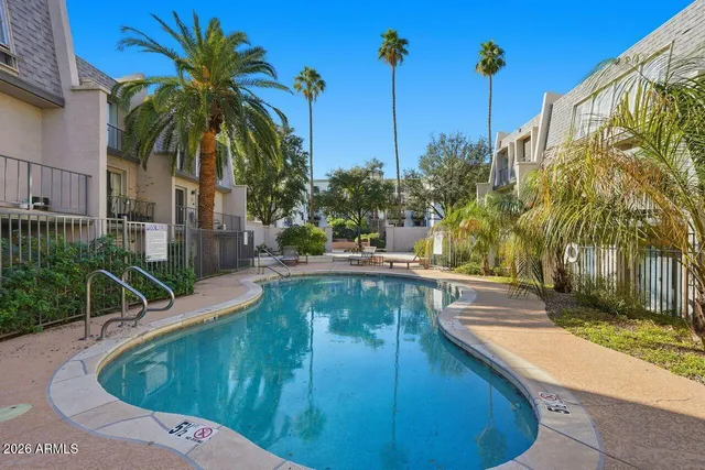 a swimming pool with outdoor seating and yard