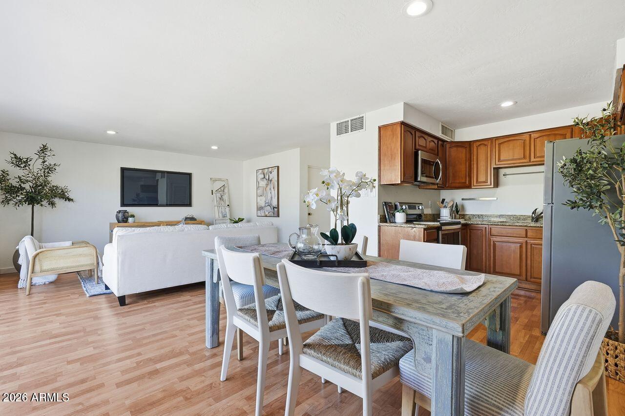 1012 East Osborn Road, Unit E Phoenix, AZ 85014 - Photo 9 of 22 a living room with stainless steel appliances a table and chairs