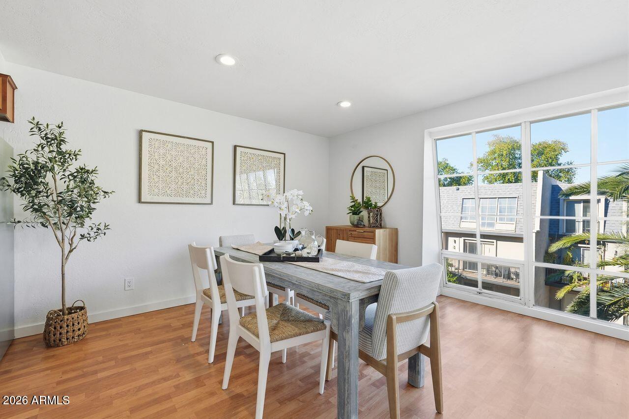 1012 East Osborn Road, Unit E Phoenix, AZ 85014 - Photo 10 of 22 a view of a dining room with furniture window and wooden floor